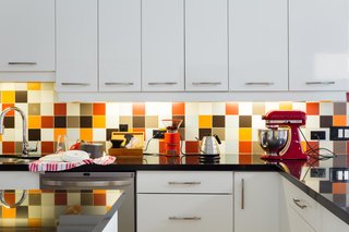 This Century-Old Bungalow Is an Eternal Work-in-Progress - Photo 2 of 4 - The backsplash is an exuberant mix of colorful tile. "We used a randomizer algorithm to design the multi-colored non-pattern," says Lori. 