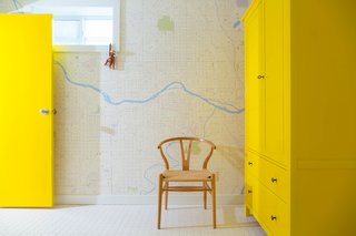 25 Bold Ways to Decorate with Yellow - Photo 24 of 25 - While addressing plumbing problems, the residents took time to spruce up the bathrooms, adding new tile, fixtures, and, in one, a cheery yellow cabinet.
