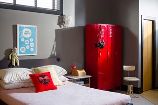 This Century-Old Bungalow Is an Eternal Work-in-Progress - Photo 4 of 4 - A red gym locker, repurposed as storage, is a whimsical touch in the bedroom.