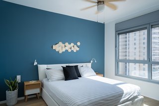 A Riotous Makeover for a Generic High-Rise Home - Photo 2 of 3 - Dollops of black define the open-plan area, but in the bedrooms, brighter colors prevail. 