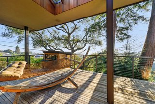The home’s deck extends outward toward a vista. General contractor McCutcheon Construction was tasked with improving insulation and installing double-pane windows throughout. 