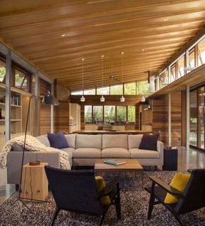 Channeling Midcentury Modern in Northern California - Photo 2 of 7 - Two black CH25 chairs by Hans Wegner mirror the baby grand piano behind them. The built-in millwork is custom by the architects. 