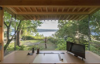 The workstation and the cabinets are by Korben Mathis Woodworking; the desk lamp is <br>from TaoTronics.