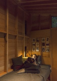 Opposite Jim’s workstation, the modest interior accommodates a single bunk—Hannah’s preferred reading perch. 