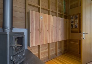 Outfitted with Woolrich linens and pillows designed by Jim’s wife, Beth Wheeler, <br>the bed is wall-mounted with a hinge from McMaster Carr, so it can be folded up when not in use. 
