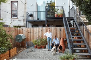 It feeds their backyard garden, which also features permeable paving rocks, a composting <br>bin, and a surrounding fence made <br>of knotty Western red cedar.