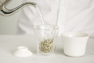 A New Prototype Design Asks: Is Tea The New Coffee? - Photo 3 of 6 - The design is made up of three components: the double-walled borosilicate glass cup with a slip-cast porcelain ceramic bowl and lid. Once the tea is ready, the lid can be pulled back to pour, no strainer required. 