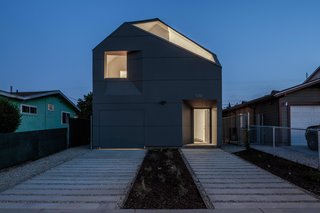 When Building a House Is the Ultimate Final Exam - Photo 7 of 8 - The new house stands out in the neighborhood, illuminated at night. 