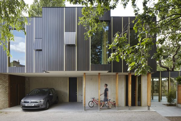 This Modern Courtyard Home Celebrates a 100-Year-Old Tree - Photo 3 of 8 - The aluminum was manufactured by Baileys Aluminum. The gold-anodized aluminum was supplied by Neville Precision Engineering. 