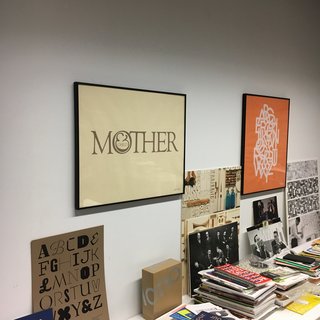 Shot taken within the Herb Lubalin Study Center the original "Mother & Child" logo, to the right "ABCDEFG..." the alphabet set in Avant Garde Gothic, designed by Herb Lubalin and Tom Carnase. One of many examples of typically Lubalin-esquen arrangement of interlocking and overlapping letterforms. 1974
