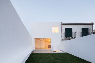 Spotlight on Portugal: 7 Epic Modern Spaces - Photo 3 of 7 - The residence is characterized by townhouses of two floors with about 40m2 each and two backyards. Illustrated by very small and compartmentalized spaces, the main challenge of these houses is the adaptation to a contemporary experience, and the need for larger spaces with a relationship with the outside. The project was developed based on an organizational principle of hierarchy. Each floor corresponds to a particular program so that the areas could be exploited to the maximum, generating spaces with quality. 
