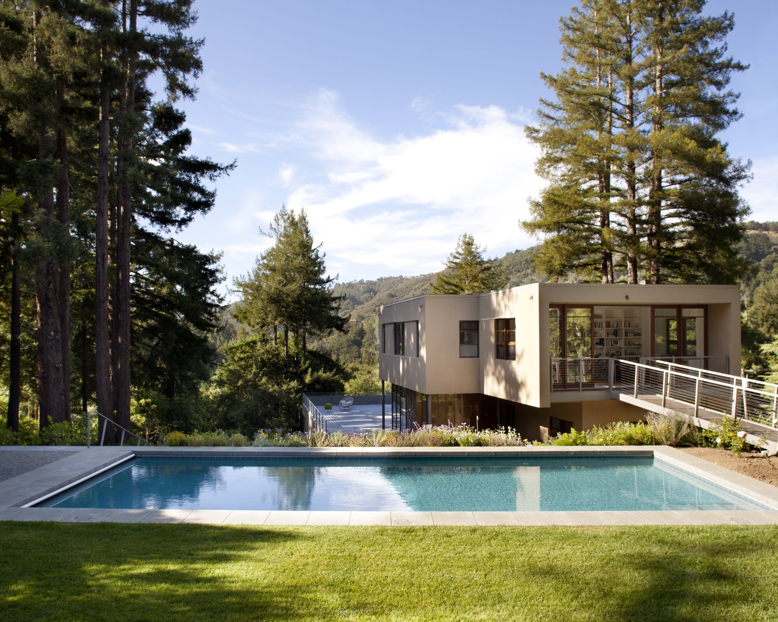The ramped bridge that leads to an upper yard and pool
