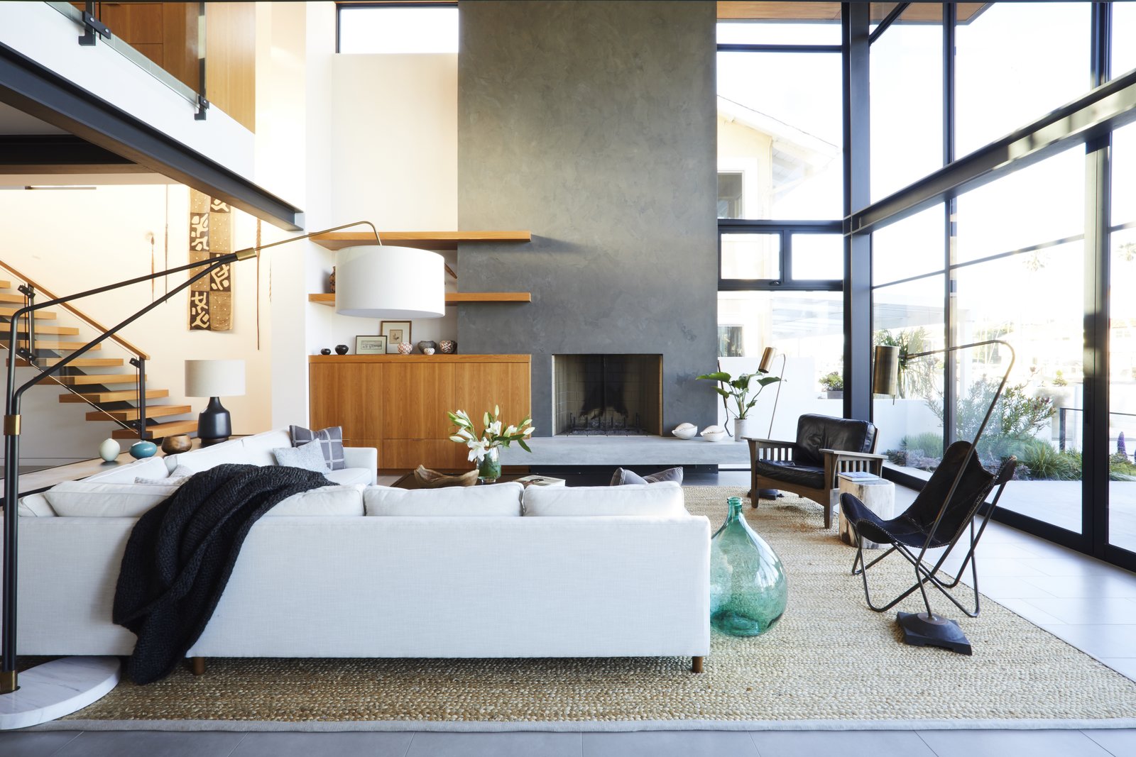 A cream-colored Mitchell Gold + Bob Williams sectional designates the living area in this open concept, as does a Kochi Pattern rug from the Taj Collection at Area Rug Factory.