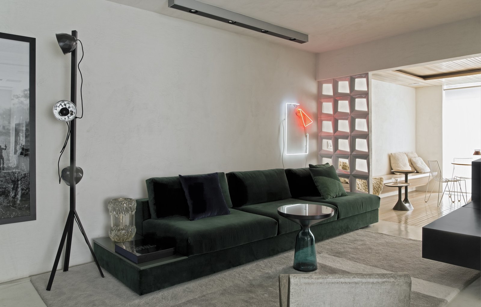 A Brazilian Bachelor Pad Embraces Light and Darkness The small partition that separates the living space from the dining area is common in Brazilian homes. Revollo chose it for its character and tradition — as well as the fact that it still lets light in.