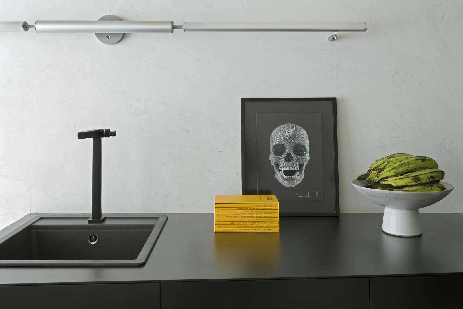 A Brazilian Bachelor Pad Embraces Light and Darkness Inovart Woodworking helped create the metal sheet shelf in the common area.