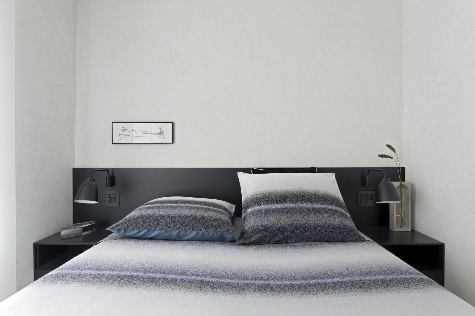A Brazilian Bachelor Pad Embraces Light and Darkness The black lacquer finish used in the common area was repeated in a headboard for the master bedroom.