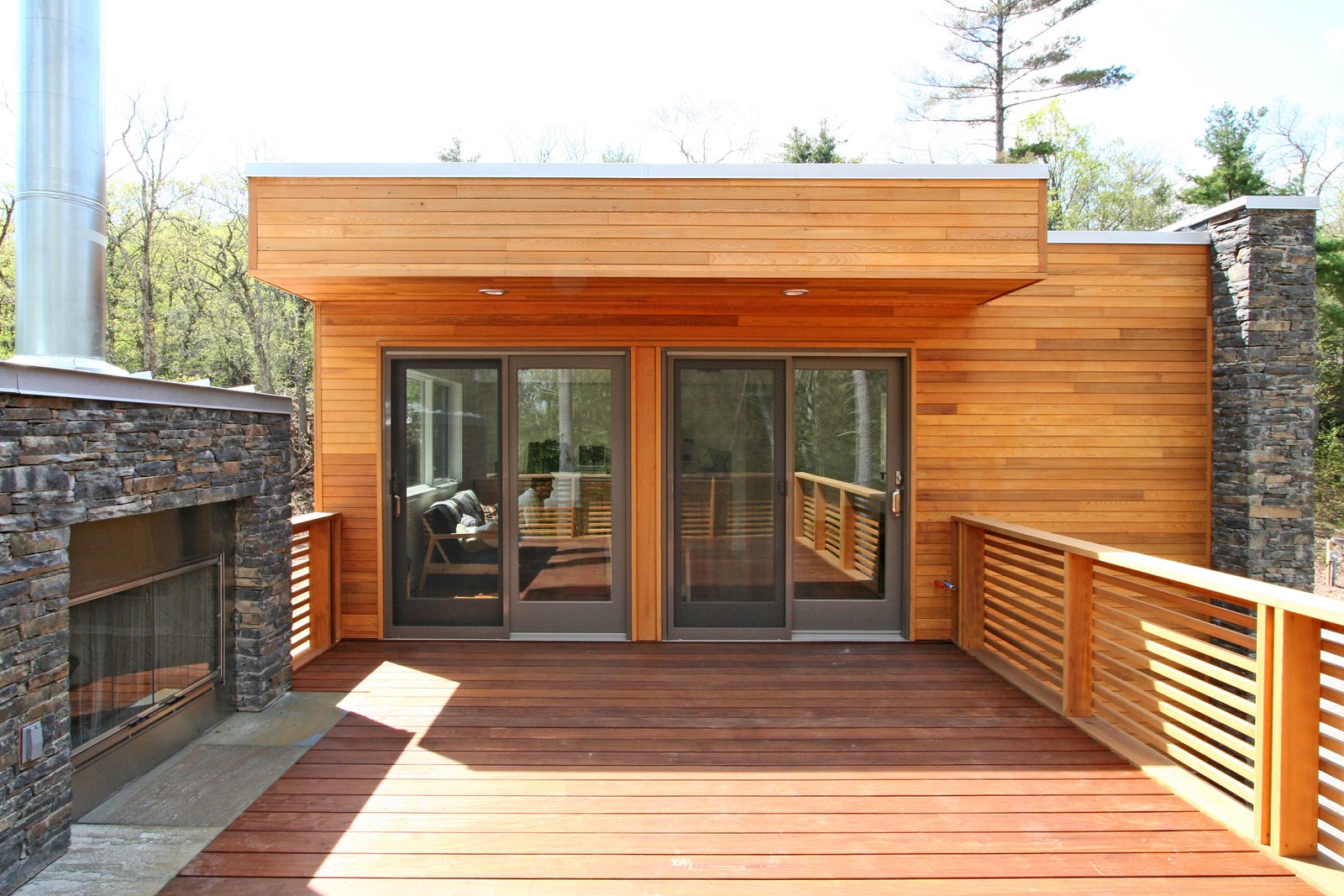 Ipe roof deck with outdoor fireplace and stone surround
