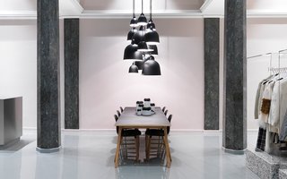 Normann Copenhagen's Revamped Showroom and Flagship Store - Photo 1 of 12 - Bell lamps in various sizes hovering above the Slice table.
