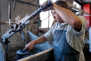 Sausalito Dinnerware Factory Tour - Photo 4 of 35 - This process is called manual jiggering. An inner profile of a form is pulled down and spreads the clay into a rotating plaster form. Water is sponged on to each piece to smooth the surface. Our automated jigger machines make bowls by spreading clay into a spinning plaster mold.