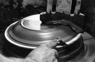 Sausalito Dinnerware Factory Tour - Photo 5 of 35 - This in an archival photograph showing a plate being formed in the 1950's on a manual jiggering machine.