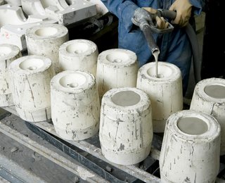 Sausalito Dinnerware Factory Tour - Photo 10 of 35 - Liquid clay (slip) is poured into the mold until it fills to the top. After a wall thickness dries, the remainder of the slip is poured out, and can be reused in the next pour.