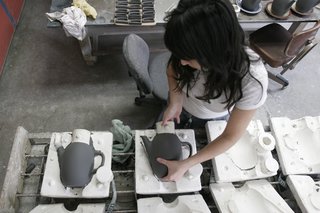 Sausalito Dinnerware Factory Tour - Photo 11 of 35 - After sitting for about half an hour the clay is firm enough that the cast forms can be removed from the molds. More drying is required before the pieces can be trimmed.