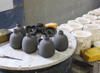Sausalito Dinnerware Factory Tour - Photo 12 of 35 - The vases need to be trimmed and wiped in order to remove the mold seam.