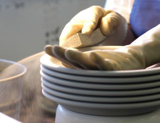 Sausalito Dinnerware Factory Tour - Photo 15 of 35 - Each piece is wiped with a wet sponge to smooth the surface.