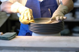 Sausalito Dinnerware Factory Tour - Photo 17 of 35 - After trimming, the final step before glazing is wiping down the piece with a wet sponge. This smooths the surface and gives it a hand-finished texture.