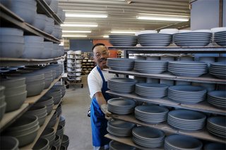 Sausalito Dinnerware Factory Tour - Photo 18 of 35 - Trimmed pieces are placed on wheeled carts and moved to the next process. These pieces are trimmed, dry and ready for glazing.