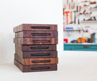 Jacob May Design - Photo 1 of 7 - A stack of finished walnut butcher blocks sits in his studio. Dave carefully reads the grain of the wood to create beautiful patterns. On average, each piece takes about 5 hours to make from start to finish.