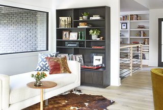 Cade studio sofa, Madison end table, Keaton bookcase, Cowhide rug, Maze pillow 