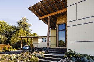 The simple, modern volumes of the structure are accented with natural finishes and personal touches such as the locally salvaged eucalyptus posts that support the roof and mark the entry, along with salvaged cedar siding.