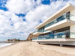 Rebuilt, Redesigned, Reimagined: An architectural jewel on one of Malibu's premier beaches, this coastal contemporary home enjoys panoramic vistas of the Pacific. Masterful design and state-of-the-art technology make for truly modern coastal living. Presented by Sotheby’s International Realty – Sunset Strip Brokerage.