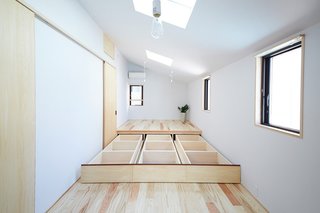 This Japanese home features a clever built in storage design—a "hidden space," under a raised platform.