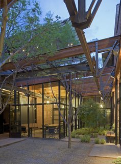 9 Inspirational Examples of Adaptive Reuse - Photo 5 of 9 - Armstrong Oil and Gas in Denver, Colorado. Designed by Lake|Flato Architects. Winner of the 2011 Institute Honor Award for Interior Architecture. Project description: "The adaptive re-use of a 1900s machine shop celebrates the spirit, craft and materiality of its original program. The transformed spaces are organized around a new landscaped courtyard created by stripping away the center section of the existing roof to bring in natural light and ventilation to the interior spaces. A gated entry court on the street front acts as a threshold to the courtyard framed by two brick volumes containing the building’s public spaces on one side and office spaces on the other."