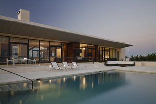  Seen here is the ocean-facing side, with a zinc-clad cantilever shading that covers a sprawling outdoor patio.