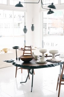 The floor-to-ceiling windows stream the dramatic Pacific Northwest lighting into the bright and airy showroom, which no doubt draws many-a-customer into the stunning space.
