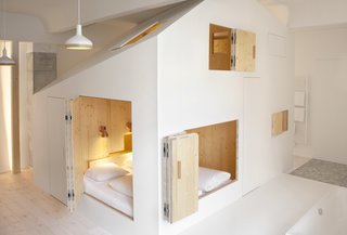 Gestalten's New Book Shows How to Transform Small Spaces Into Design Marvels - Photo 3 of 16 - Room 304 is a hotel suite in Berlin's Michelberger Hotel designed by Danish architect Sigurd Larsen. It's one of 100 unique suites within the hotel. From the outside, the bedroom "cabin" is painted white, but the interior is warm and cozy—thanks to the light colored timber. 