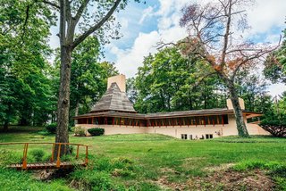 10 Frank Lloyd Wright Homes Available to Rent Right Now - Photo 10 of 10 - The Dr. Richard Davis House, also known as "Woodside," is situated on a wooded two-acre lot in an established and conveniently located neighborhood in Woodside, Indiana. This unique home, which is on the National Registry of Historic Places, was built in 1952 and has been completely renovated by the current owner. 