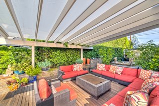 On the Market For $4.5M, This Venice Beach Compound Captures the Essence of Indoor-Outdoor Living - Photo 1 of 8 - The interiors of the 3,200-square-foot main house have been decked out with attention to high-quality construction and first-rate architectural details. The open cook's kitchen features a built-in dining area and breezy outdoor access. 
