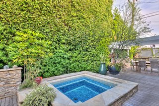 On the Market For $4.5M, This Venice Beach Compound Captures the Essence of Indoor-Outdoor Living - Photo 2 of 8 - Set back behind mature landscaping, the private, enclosed deck also boasts a built-in spa. 