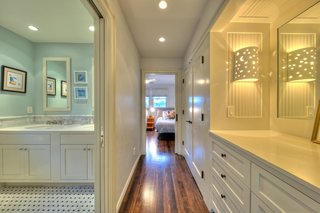 On the Market For $4.5M, This Venice Beach Compound Captures the Essence of Indoor-Outdoor Living - Photo 5 of 8 - The children's bedroom features ample storage and a private bath.