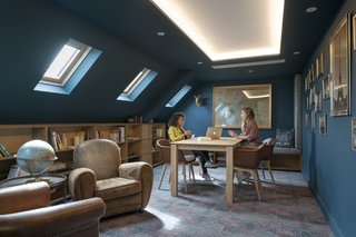 Take a Peek Inside Airbnb's New Loft-Inspired Office Space in Paris - Photo 5 of 13 - Cove lighting is found interspersed throughout the office to help elevate the low ceilings and bring light into previously dark spaces.