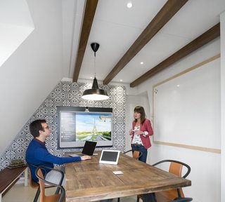 Take a Peek Inside Airbnb's New Loft-Inspired Office Space in Paris - Photo 4 of 13 - With a traditional mansard roof and exposed beams, the office resembles a quaint attic loft that's synonymous the city's architecture.