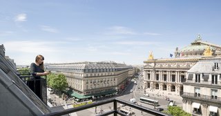 Take a Peek Inside Airbnb's New Loft-Inspired Office Space in Paris - Photo 13 of 13 - The balcony offers guests and staff incredible views of the Eiffel Tower and Opera Garnier.