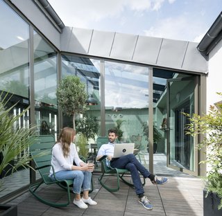 Take a Peek Inside Airbnb's New Loft-Inspired Office Space in Paris - Photo 2 of 13 - Taking inspiration from historical greenhouses, this bright and open transitional space offers the comforts of an intimate roof garden.