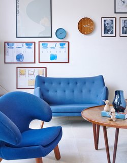 Get Your Fix of Midcentury Scandinavian Design at This Copenhagen Hotel - Photo 2 of 8 - The mood is set with a Poet sofa and Pelican chair by Finn Juhl, vintage prints, and a coffee table from Tove and Edvard Kindt-Larsen. 