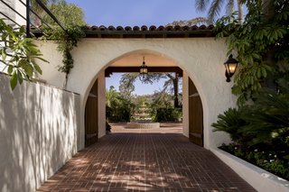 Just Listed at $4M, This Spanish Colonial Revival in Southern California Promises Resort-Like Living - Photo 1 of 8 - Historic charm abounds throughout the property with terracotta tiled arches and white stucco walls. 