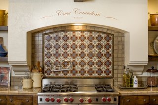 Just Listed at $4M, This Spanish Colonial Revival in Southern California Promises Resort-Like Living - Photo 3 of 8 - Hand-painted tiles make for a charming backsplash. The kitchen was designed in collaboration with Fleetwood Joiner and & Associates to closely match the style of the home. 